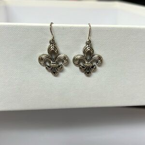 Fleur de Lis pierced earrings.